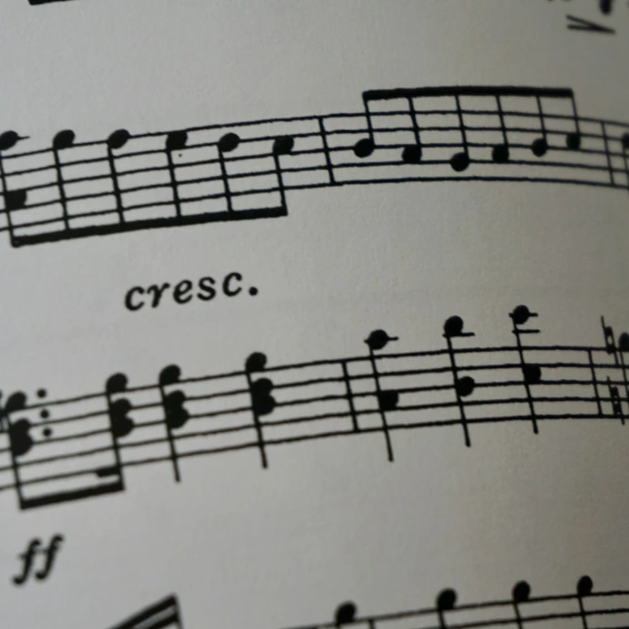 a close up of a book with musical notes